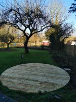 Circular decking being formed in the garden of a 17th century property