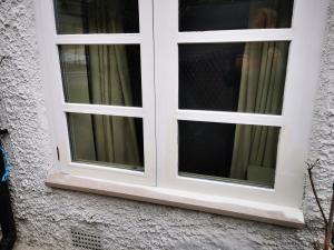 Flush window casement with replaced sections in primer undercoat