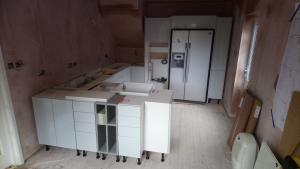 Sea Foam gloss kitchen installation, kitchen has been enlarged by stealing a part of adjacent bathroom, fully replastered