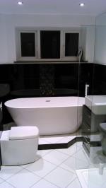 Black and white gloss bathroom with feature mosaic strips