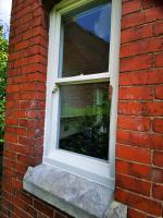 Replaced lower sections of a sash window in primer