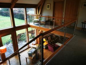 Oak constructed property with glass and oak balustrade