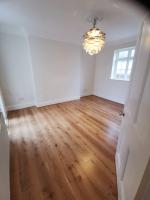 Extensively altered room finished in rustic oak flooring