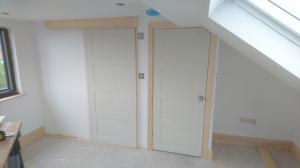 Loft bedroom doorway with adjacent sliding bathroom door