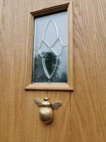 Very heavy brass bee door knocker on oak cottage external door