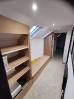 Loft landing storage formed with shaker cupboards and bench seat cubbies