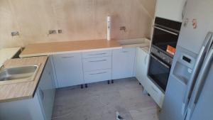 Sea Foam gloss kitchen installation, kitchen has been enlarged by stealing a part of adjacent bathroom, fully re-plastered and re-wired