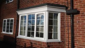 Bay window having had replacement mouldings around the head