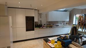 white gloss handleless kitchen fitted ready for worktops