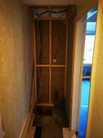 Heating services cupboard formed where staircase once stood