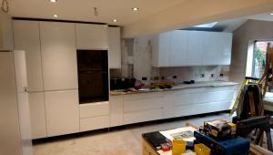 white gloss handleless kitchen fitted ready for worktops