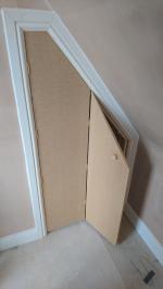 Cupboard with bi-folding door built into the pitch of a loft conversion