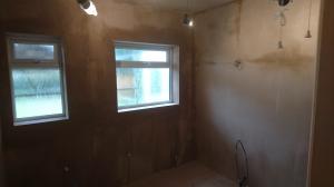Bathroom and toilet knocked together, boarded and plastered