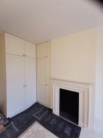 Shaker style wardrobes painted Belvoir cream with brass knobs and fittings