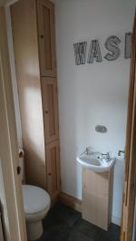 Tall and slim shaker style cupboards formed in ground floor wc