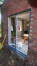 Full-house window and doorframe replacement, fitting softwood stormproof window casements and oak external doors.