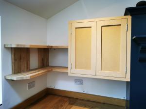 Forming cupboards to match existing painted kitchen with oak shelving