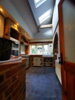 Forming vaulted ceiling in kitchen with twin veluxs and oak beams