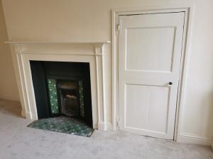 Historic door eased to open over modern carpet