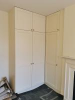 Shaker style wardrobes painted Belvoir cream with brass knobs and fittings