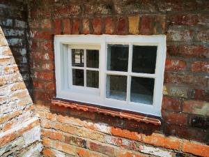 Horizontal sash after refurbishment and putty placed in primer