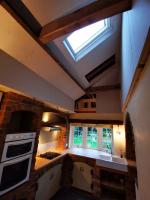 Forming vaulted ceiling in kitchen with twin veluxs and oak beams