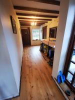 Laying engineered wood floor through an historic property hallway
