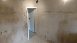 Bathroom and toilet knocked together, boarded and plastered