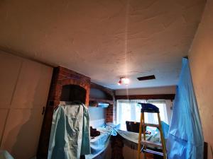 Inspection hole formed in kitchen ceiling to check feasibility of vaulted ceiling