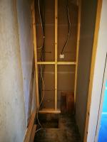 Heating services cupboard formed where staircase once stood,