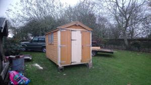 Garden shed extended and widened to house tractor