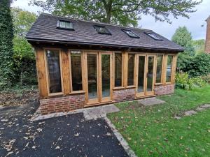 Fitting glazing and doors to oak garden building