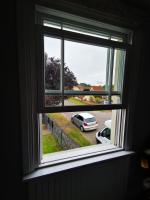 A previously failing modern sash window having had replacement tensioners