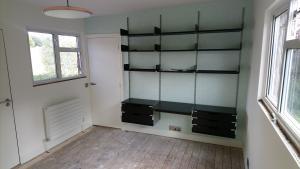 Home office formed with flush doorway, feature radiator, electrics, decorating and modular desk system