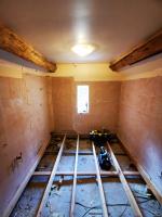 Bathroom stripped back revealing lime ash floor in a 17c property