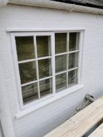 Georgian-style window casement after refurbishment, primer and putty