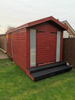 5m long garden office / workshop treated in mahogany stain