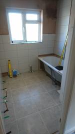 Bathroom plastered and bath fitted, undergoing tiling