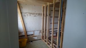 Partition wall being built to split one bathroom into two