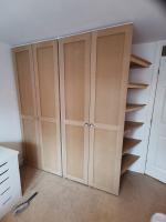 Basic shaker style wardrobes with integral mirrors, drawers and angled side shelves