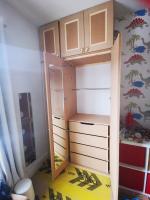Triple bank of wardrobes in a childs bedroom with drawers, mirror and Victorian shaker style doors