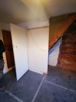 Preparing for removal of a staircase and studwall, the re-opening of a bricked-up doorway