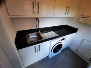 White gloss wall cabinets to match existing with new sink and tap
