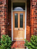 Traditional four panel external door with upper glazing