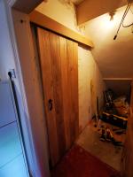 Adding a rustic oak sliding door beneath a stair-pitch to access WC