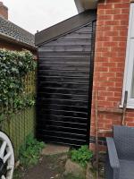 5m long storage lean-to finished in ebony stain