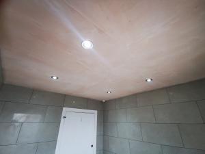 bathroom being refurbished, tiles grouted, spotlights installed
