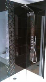 Black and white gloss bathroom with feature mosaic strips