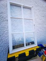 Window sash with replacement bottom rail and putty