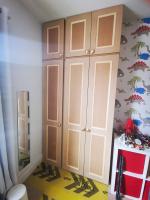 Triple bank of wardrobes in a childs bedroom with Victorian shaker style doors